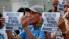 FILE - Protesters display placards during a prayer vigil in Manila, Philippines, for the victims of an explosion in Davao City, Philippines, Sept. 3, 2016. Suspected Abu Sayyaf extremists detonated a bomb at the night market in Davao City, killing a number of people and injuring dozens.