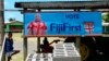 A FijiFirst poster with the image of Fiji Prime Minister Frank Bainimarama hangs at the entrance to a village in Nausori, Fiji, Nov. 7, 2018. Opinion polls indicate Bainimarama is poised to win a second term in Fiji's general election Wednesday after he f