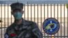 FILE - A South Korean marine wearing a mask stands in front of the navy base after a member of the unit was confirmed to have been infected with the coronavirus on Jeju Island, South Korea, Feb. 21, 2020.