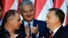 Hungarian PM Viktor Orban (R) celebrates with his party leader of their governing FIDESZ party, vice-president Lajos Kosa (L) and deputy prime minister Zsolt Semjén of the Christian Democratic People's Party in Budapest, Oct. 2, 2016.
